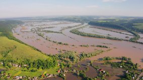 4K aerial - a bird's eye view video (Ultra High Definition). Flood on the Dniester River, Ivano-Frankivsk region. Car bridge among the flooded pastures and fields in western Ukraine, Europe.