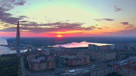 SAINT PETERSBURG, RUSSIA - AUGUST 8, 2020: Aerial view of the skyscraper Lakhta Center and Atlantic City at pink sunset. Drone flight over the city in the evening.
