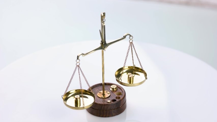 Golden scales of justice. Unbalanced scales isolated on white background.