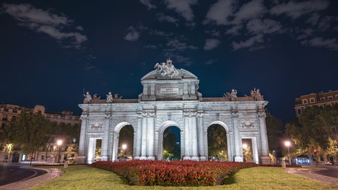 Madrid, Spain; 08/06/2020: 4K night timelapse of Puerta de Alcala with traffic on the sides in Madrid, Spain