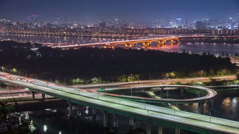 Time lapse of bridges and Cars passing in intersection, Han River at Night in Downtown Seoul city, South Korea