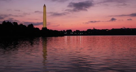 The sun rises behind the Washington Monument at the Tidal Basin on the National Mall.