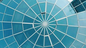 Top view on Structural glass facade curving roof of office building. Modern and contemporary architectural fiction with glass steel column. Aerial shot of glass dome construction - Powered by Shutterstock - Get 15% off with code: PIKWIZARD15