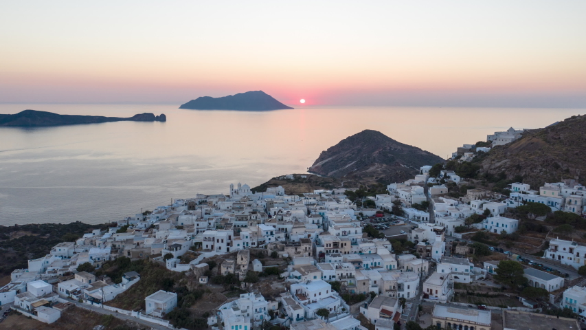 Aerial Hyper Lapse Moving Time Lapse above Typicall Greek Village at Sunset on Milos, Greece Island with Ocean View, Hyperlapse Royalty-Free Stock Footage #1057289029