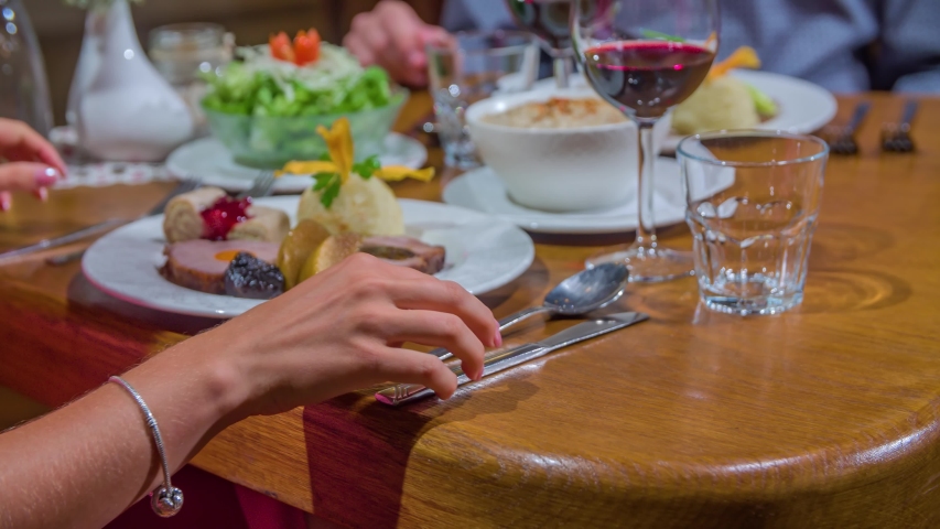 Woman impatiently holding cutlery, wants to start dinner but being stopped to begin to eat | Shutterstock HD Video #1057299355