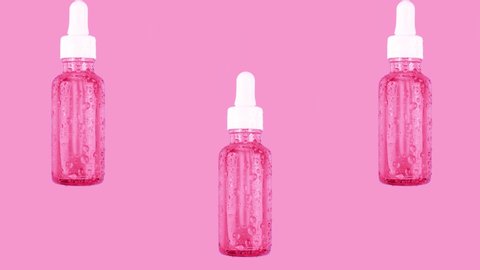 Essence moisturizing serum in glass bottle fly down on trendy pastel pink background. Animation. Hyaluronic acid for hydration. Cosmetics concept. Products for makeup and skin care. Looping video.