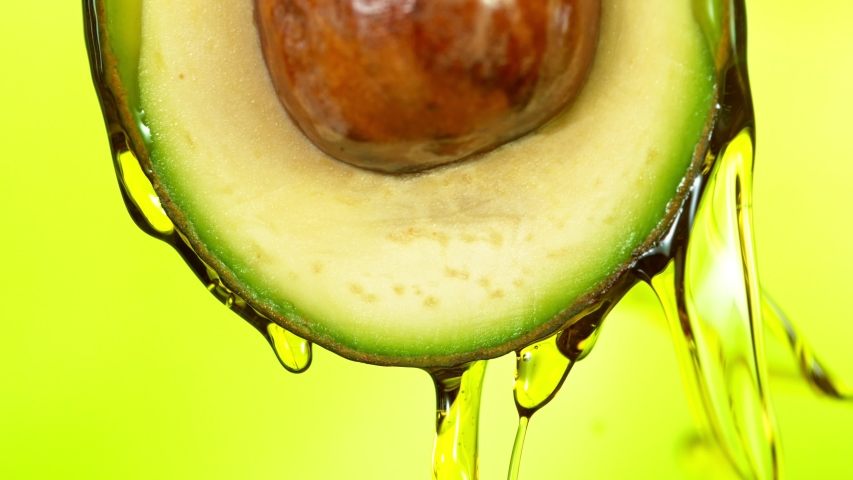 Fresh cut avocado with oil stream. Concept of healthy fruit also useful in cosmetics. Shot with high speed cinematic camera, super slow motion Royalty-Free Stock Footage #1057299799