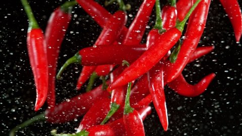 Super Slow Motion Shot of Flying Red Chilli Peppers, Collision in the Air at 1000fps.