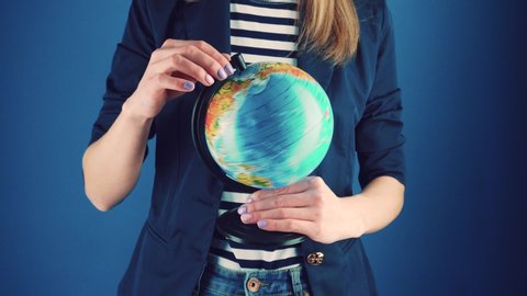 travel agent girl with globe on a blue background. travel concept