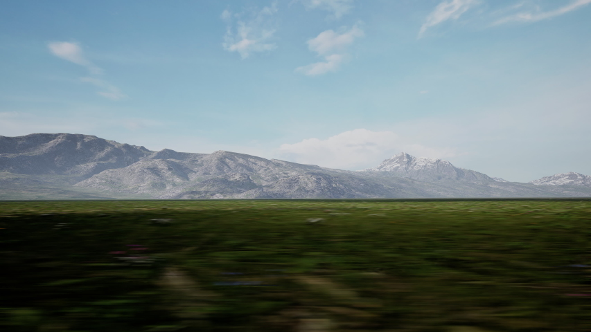 DRIVING PLATE DX Car driving fast on a scenic road, mountains in the background