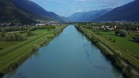 Aerial flying along the Adda river, a tributary of the Po, that flows into Lake Como, North Italy. Drone slow dolly back
