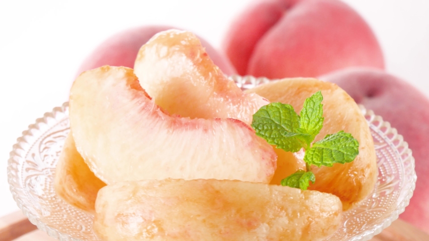 Fresh Cut ripe peaches nicely arranged on a glass plate, Rotate Royalty-Free Stock Footage #1057315861