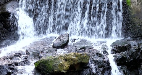 stream waterfall between rock, summer