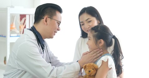 Doctor or physician touches the child neck to check for thyroid disease, tonsillitis And check the fever, the child is happy when he knows the health check results that he is normal. child with doctor