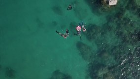 aerial freedivers in the water koh tao thailand island coastline snorkeling 