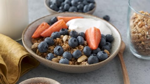 Healthy breakfast oat granola with blueberries, strawberries and greek yogurt