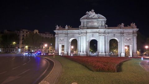 Madrid, Spain; 06/08/2020: 4K night footage of Puerta de Alcala with traffic in Madrid, Spain
