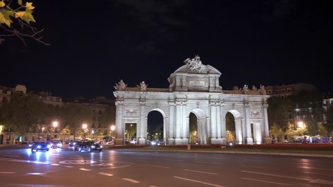 Madrid, Spain; 06/08/2020: 4K night footage of Puerta de Alcala while the lighting of the monument goes out with traffic in Madrid, Spain