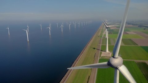 Windmill park green energy from drone view, windmill ofsshore wind farm in the Netherlands windmill turbines. High quality 4k footage