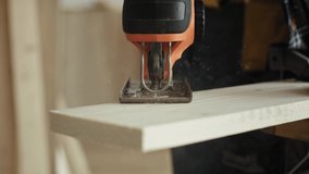 Handheld video of sawing wood with an electric jigsaw. Shot with RED helium camera in 8K