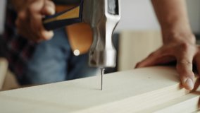 Detail video of carpenter using a hammer to drive nail. Shot with RED helium camera in 8K - Powered by Shutterstock - Get 15% off with code: PIKWIZARD15
