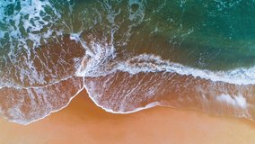 Aerial view of sea waves and sandy beach
