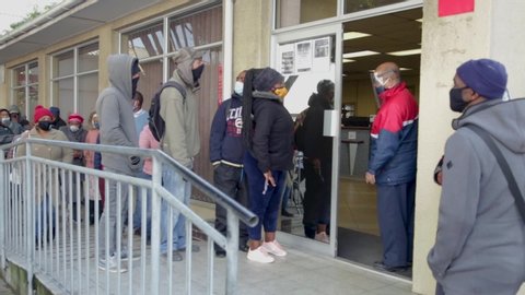 Cape Town, South Africa - August 2020: Corona Virus Relief Funds in South Africa.Unemployment rate in Africa high. People waiting hours for 20 Dollars to survive for a month. Face Masks, Pandemic.