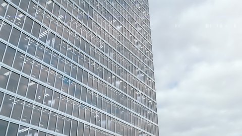 High rise office building on a background of a timelapse cloudscape. Time goes very fast and reflection of the clouds are reflects in the windows of skyscraper. 3d animation for real estate agencies.