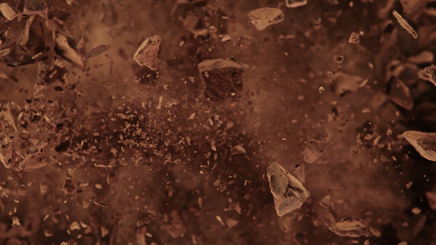 Super Slow Motion Shot of Raw Chocolate Chunks and Cocoa Powder after Being Exploded at 1000fps. Royalty-Free Stock Footage #1057336012
