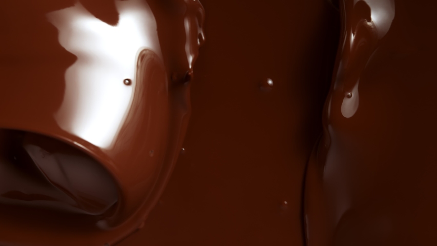 Super Slow Motion Shot of Splashing Melted Chocolate Background at 1000fps. Royalty-Free Stock Footage #1057336048