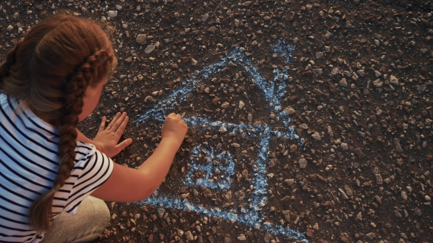 Child kid draw a house on the asphalt with chalk . childhood mortgage dream kid concept. little girl playing draws with chalk big house. concept loan mortgage for a dream residential home building | Shutterstock HD Video #1057346353