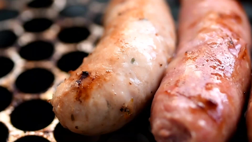 Close up of pork sausages on the grill - traditional Brazilian barbecue