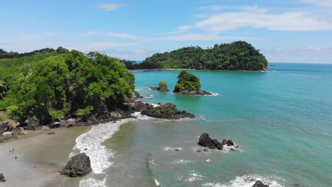 Aerial shot of the coastline including tropical vegetation at Manuel Antonio, shot directed towards Cathedral point, sunny weather. Costa Rica.