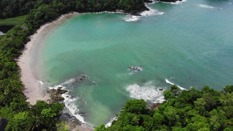 Aerial flyover shot of Manuel Antonio and Espedilla Sur beach at Cathedral Point, Manuel Antonio National Park, Costa Rica. Shot at sunny weather.