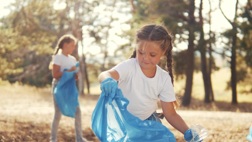 kid collecting trash volunteer teamwork. child group happy family on collects garbage plastic trash waste bottles trash. environmental happy family a teamwork volunteer awareness ecology pollution Royalty-Free Stock Footage #1057351315