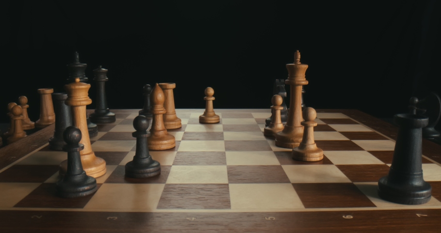 Close up of businessmen playing chess. Black figures win checkmate. Side view of black queen defeating white king during chess game isolated on black background Royalty-Free Stock Footage #1057363309