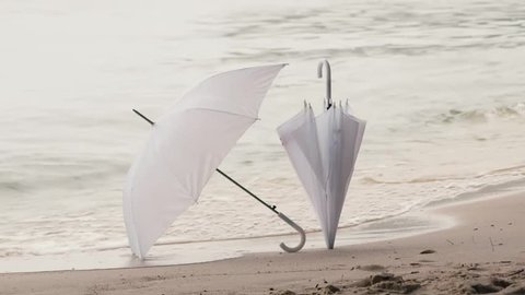 two white umbrella on a background of water