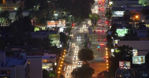 LOS ANGELES - June 29, 2015: Aerial view of traffic on Fairfax Avenue between Santa Monica Blvd and Melrose Ave at night in West Hollywood, CA. 4K UHD Timelapse.
