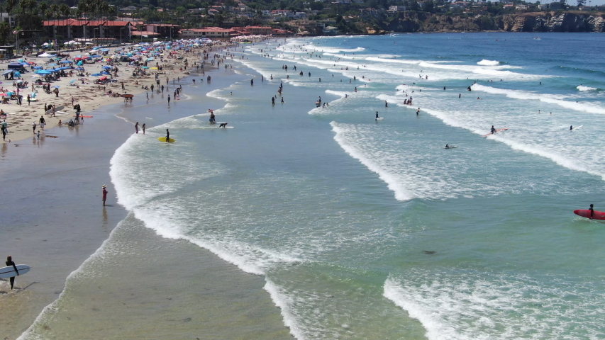 Aerial view of tourists and families enjoying the beach and small waves during summer day in La Jolla, San Diego, California, USA. Beach with pacific ocean. | Shutterstock HD Video #1057370800