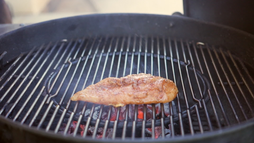 Barbecuing perfectly spice-rubbed or marinated chicken breasts on the grill - slow motion Royalty-Free Stock Footage #1057376056