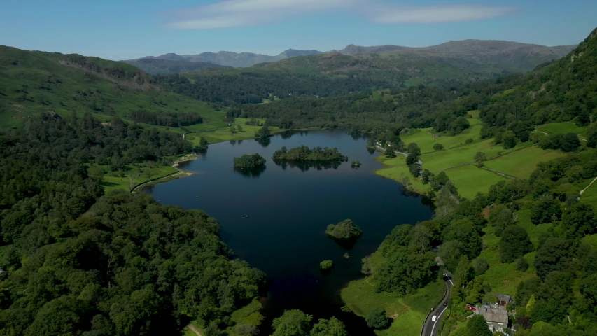 4K:  Drone Aerial Clip of Rydal Water Lake in the English Lake District, Cumbria, UK. Approach shot in Summer with Blue Sky. Stock Video Clip Footage