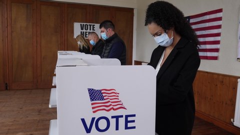 4K: Voters voting at Polling Place of the USA Election.  Diverse People Stood at booths wear Face Masks. Gimbal shot. Stock Video Clip Footage