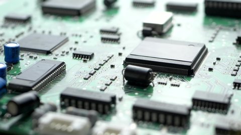 Electronic circuit board with processor, chips and capacitors. Tech science, computer chip, quality control background