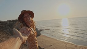 Follow me concept, couple holding hands POV of woman leading boyfriend towards cliff above sea. Couple travel concept  - Powered by Shutterstock - Get 15% off with code: PIKWIZARD15