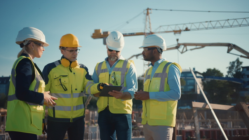 Diverse Team of Specialists Use Tablet Computer on Construction Site. Real Estate Building Project with Civil Engineer, Architect, Business Investor and General Worker Discussing Plan Details. Royalty-Free Stock Footage #1057388131