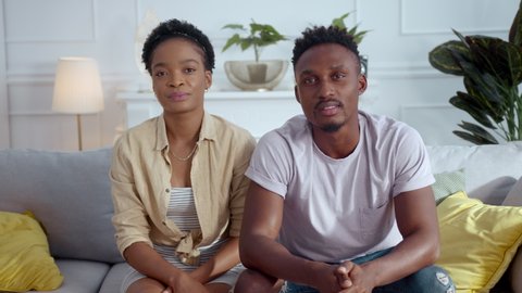 Afro-american mixed race young couple man and woman sharing family problems with psychologist talking at camera about relationships problems.