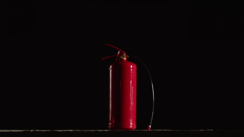 Fire extinguisher burning on black background .  Fire extinguisher and flames . Shot on ARRI ALEXA Cinema Camera in slow motion 200fps . Royalty-Free Stock Footage #1057390861