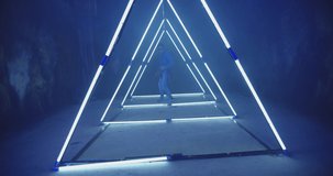 4K Professional Hip Hop break dancer . Stylish young man dancing with real strobe lights . Against blue background with triangle shape of led lights . Real decoration . Shot on RED EPIC Cinema Camera