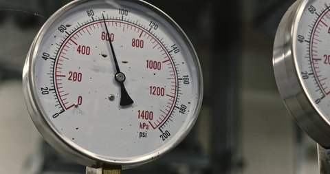 Round mechanical pressure gauges on pipelines,  pressure gauge takes a dive at nuclear electrical power plant, industrial boiler room, manometers and metal tubes, heating system, ac system, water pump