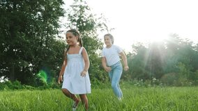 children kid dream together run in the park at sunset. happy family people in the park concept. two sisters playing catch-up run. baby child fun running in green meadow. happy family dream kid concept - Powered by Shutterstock - Get 15% off with code: PIKWIZARD15